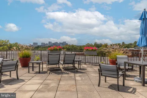 a terrace with outdoor seating city view and ocean view