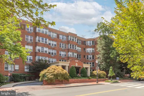 a view of a tall building next to a road