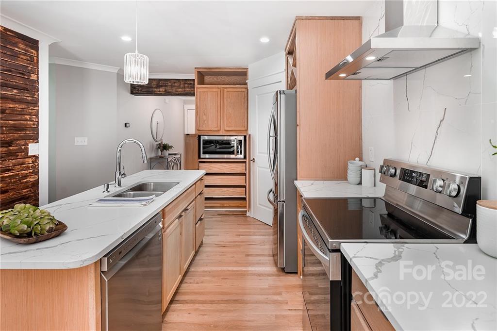 3532 Clardy Court Charlotte, NC 28205 - Photo 12 of 34 a kitchen with stainless steel appliances granite countertop a sink stove and refrigerator