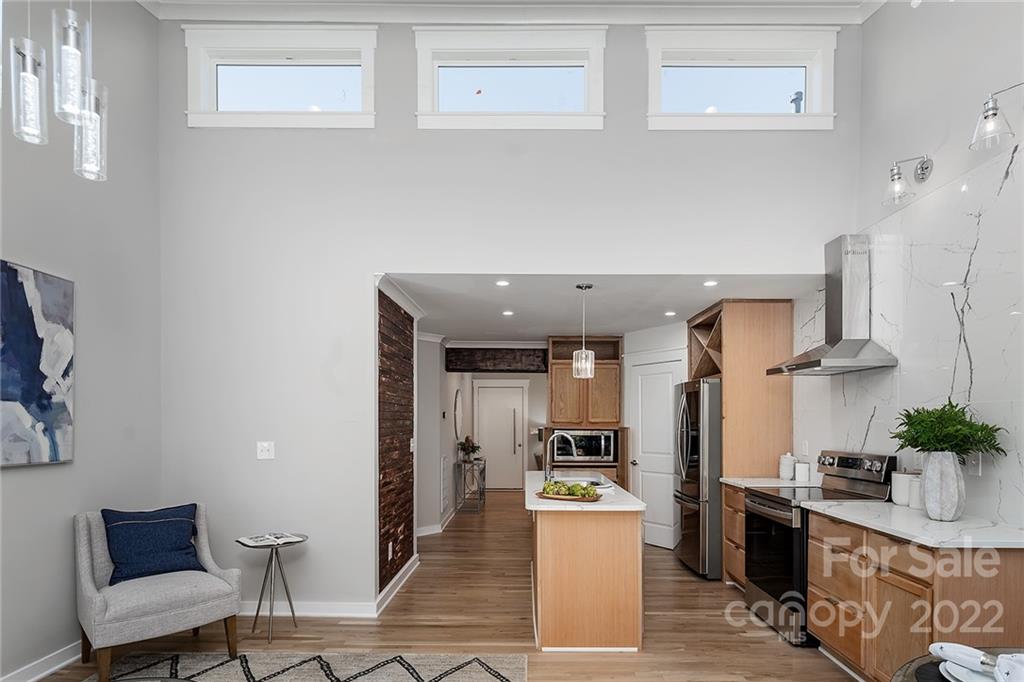 3532 Clardy Court Charlotte, NC 28205 - Photo 13 of 34 a kitchen with stainless steel appliances kitchen island granite countertop a refrigerator a stove a sink dishwasher and white cabinets with wooden floor