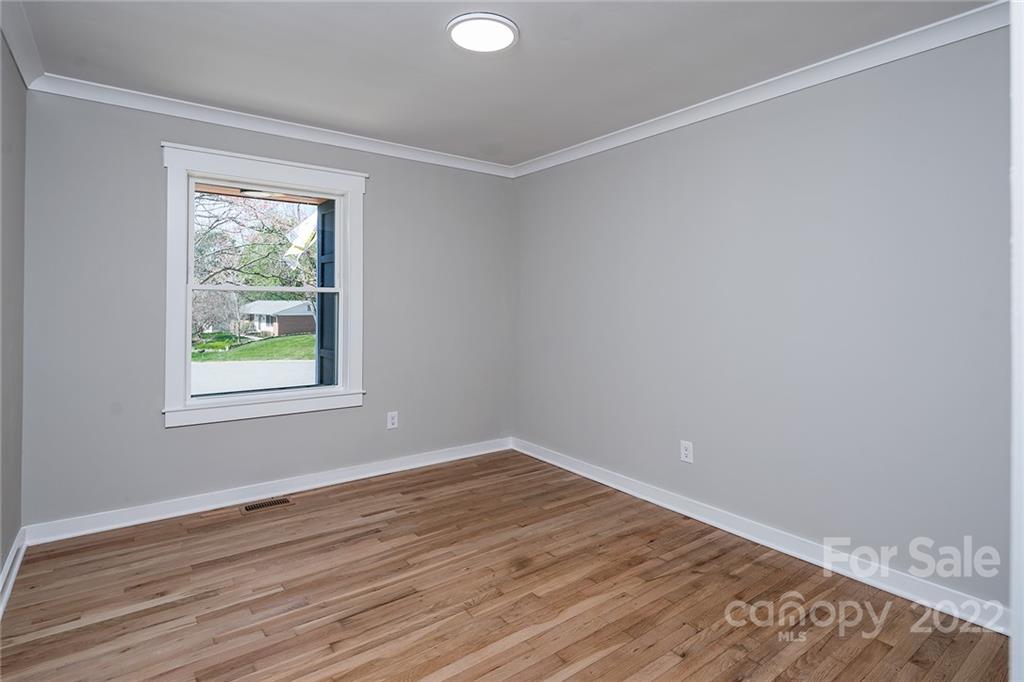 3532 Clardy Court Charlotte, NC 28205 - Photo 19 of 34 a view of an empty room with wooden floor and a window