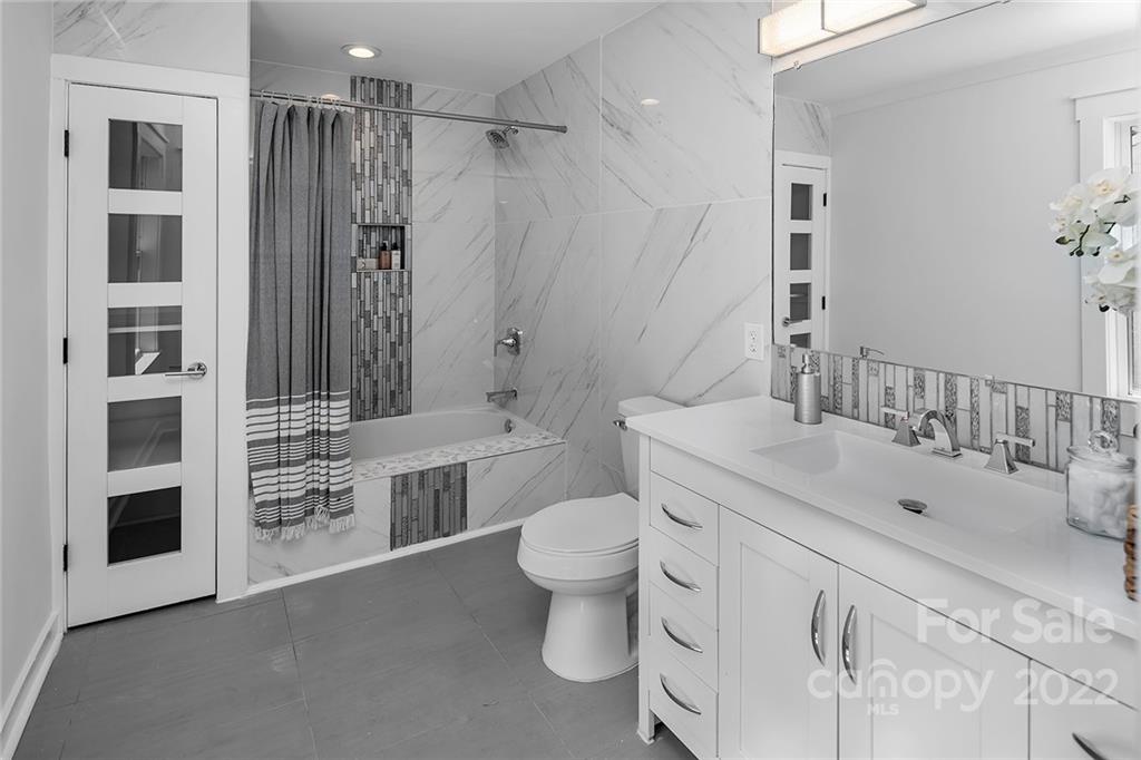 3532 Clardy Court Charlotte, NC 28205 - Photo 28 of 34 a bathroom with a double vanity sink toilet and shower