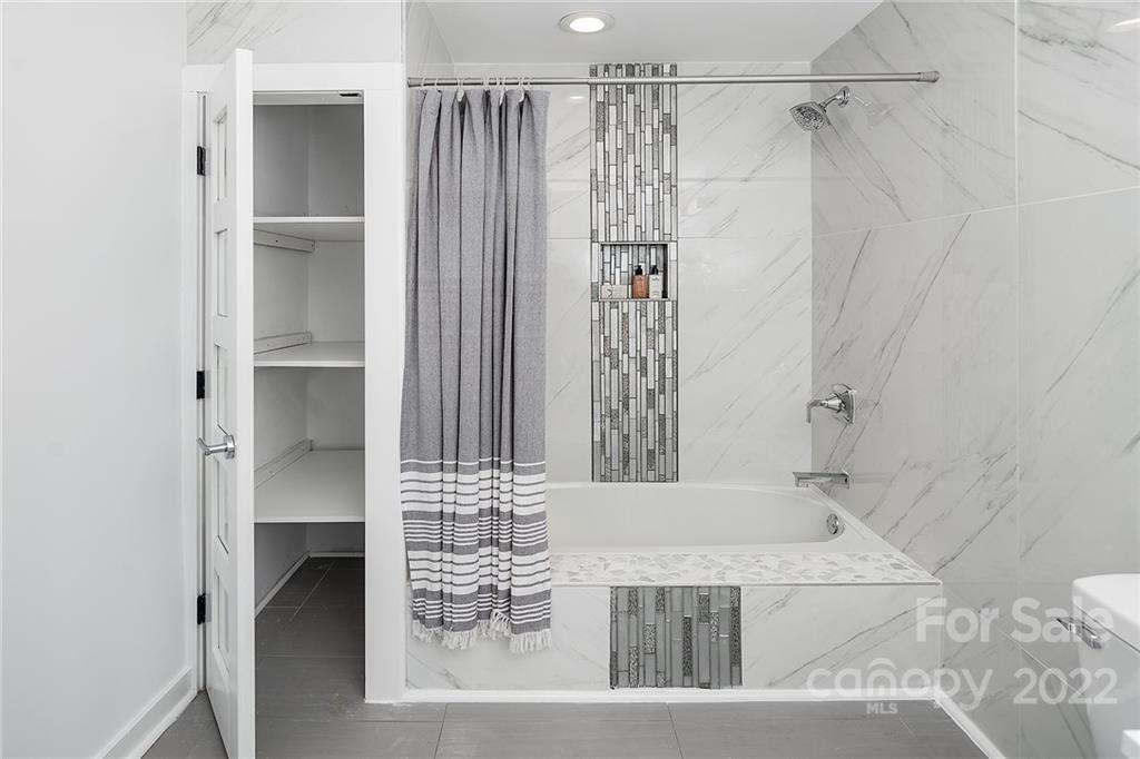 3532 Clardy Court Charlotte, NC 28205 - Photo 30 of 34 a bathroom with a bathtub and a shower