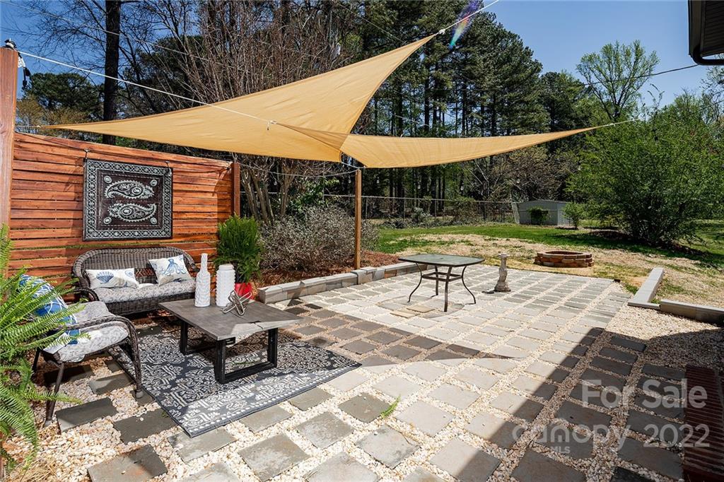3532 Clardy Court Charlotte, NC 28205 - Photo 31 of 34 a view of a patio with a table and chairs under an umbrella