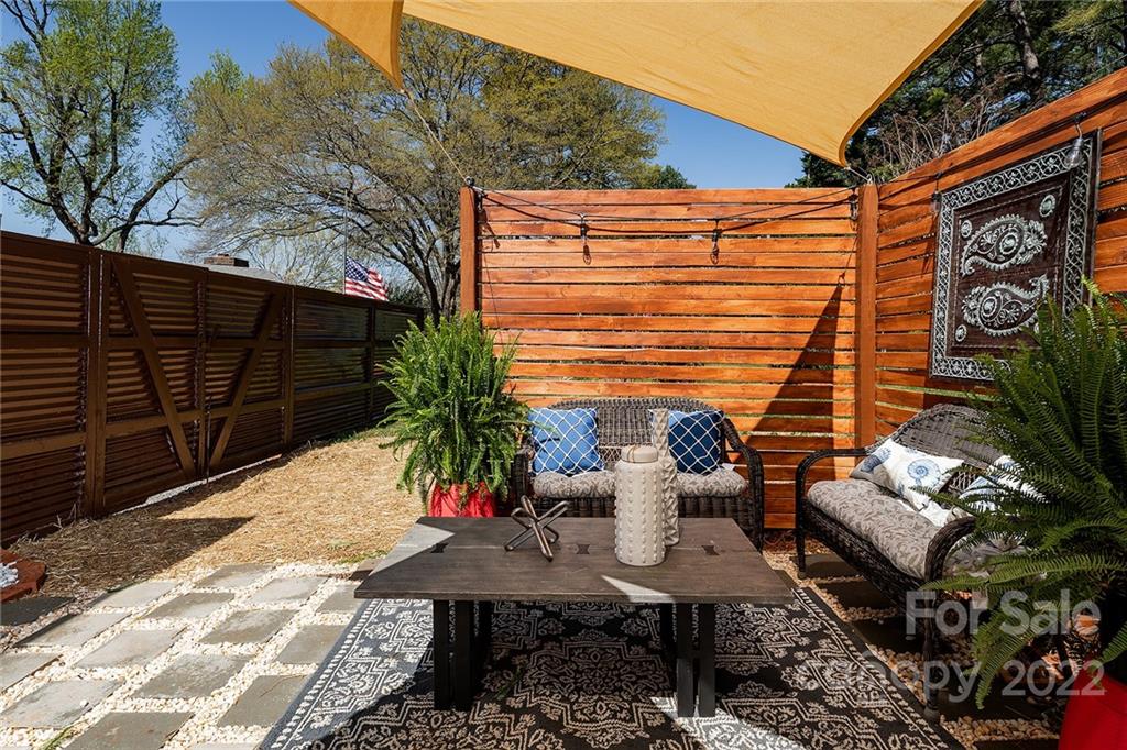 3532 Clardy Court Charlotte, NC 28205 - Photo 32 of 34 a view of a patio with table and chairs and potted plants