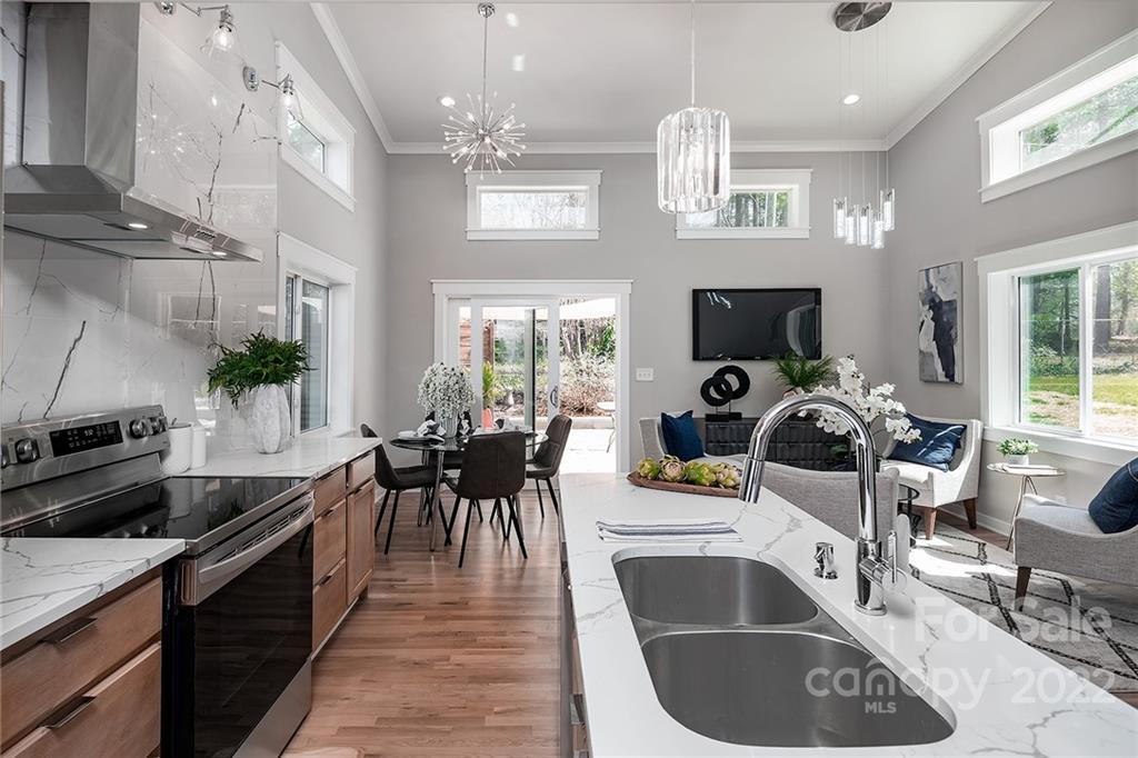 3532 Clardy Court Charlotte, NC 28205 - Photo 7 of 34 a kitchen with a sink dining table and chairs