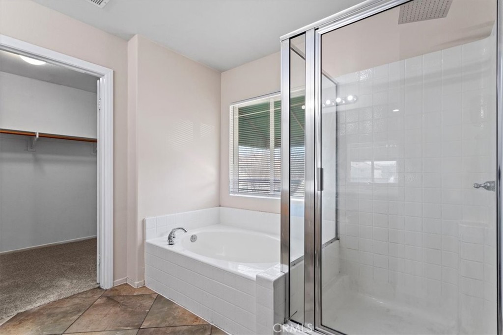 1128 East E Avenue Lancaster, CA 93535 - Photo 17 of 37 a bathroom with a bathtub and a shower