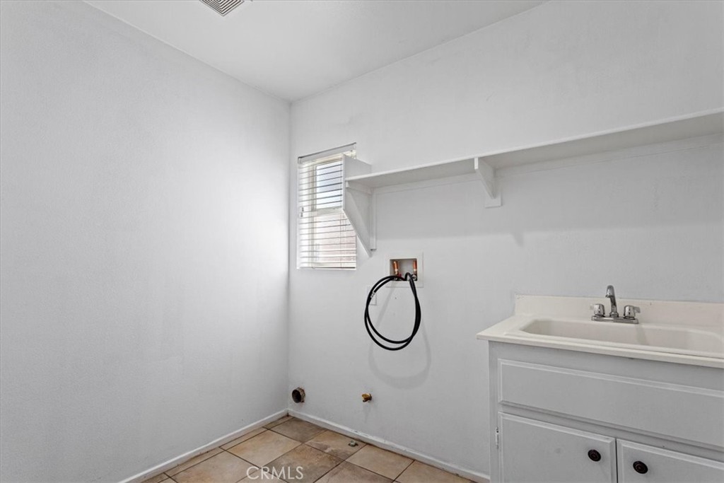 1128 East E Avenue Lancaster, CA 93535 - Photo 20 of 37 a bathroom with a sink and a mirror