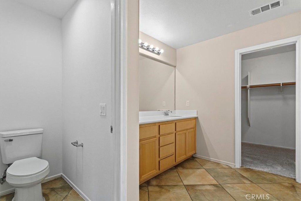 1128 East E Avenue Lancaster, CA 93535 - Photo 22 of 37 a bathroom with a sink a toilet and a mirror