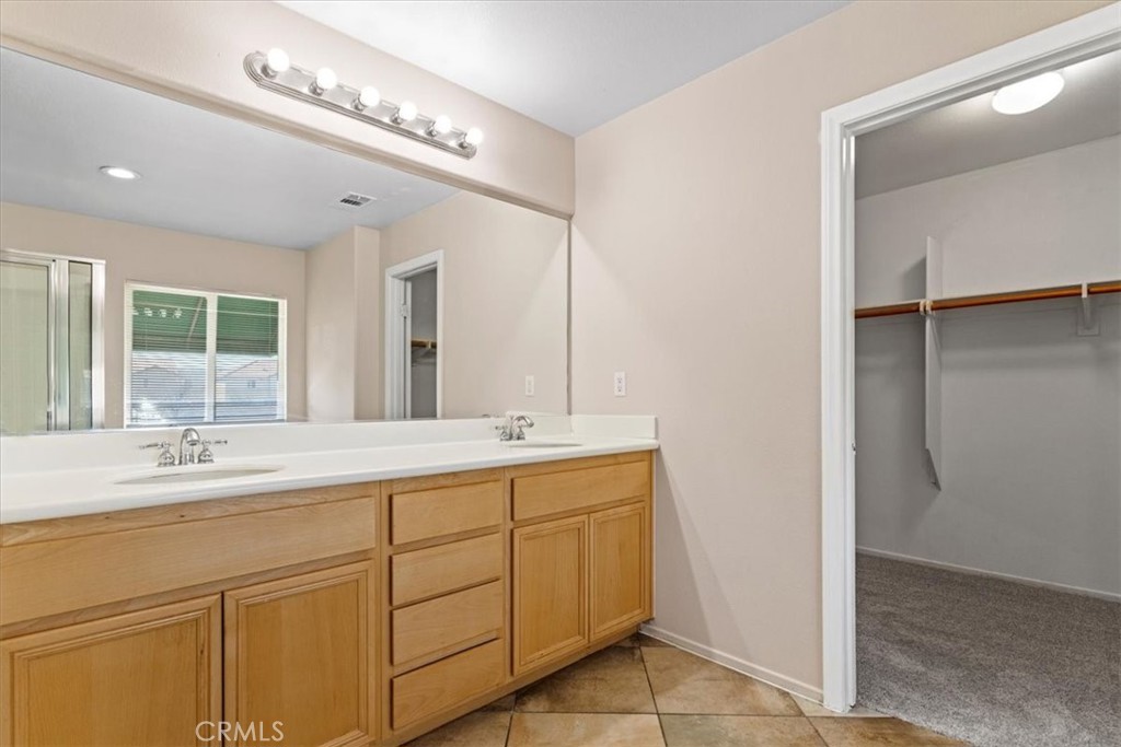 1128 East E Avenue Lancaster, CA 93535 - Photo 25 of 37 a bathroom with a double vanity sink and a mirror