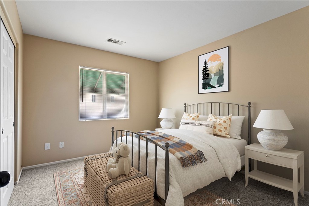 1128 East E Avenue Lancaster, CA 93535 - Photo 5 of 37 a bedroom with a bed and a couch