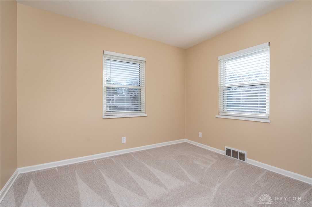 326 North Bromfield Road Kettering, OH 45429 - Photo 15 of 30 This cozy bedroom features plush carpet and ample natural light from two windows.