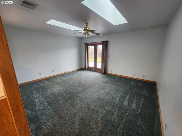 a close view of a sink and dishwasher with wooden floor