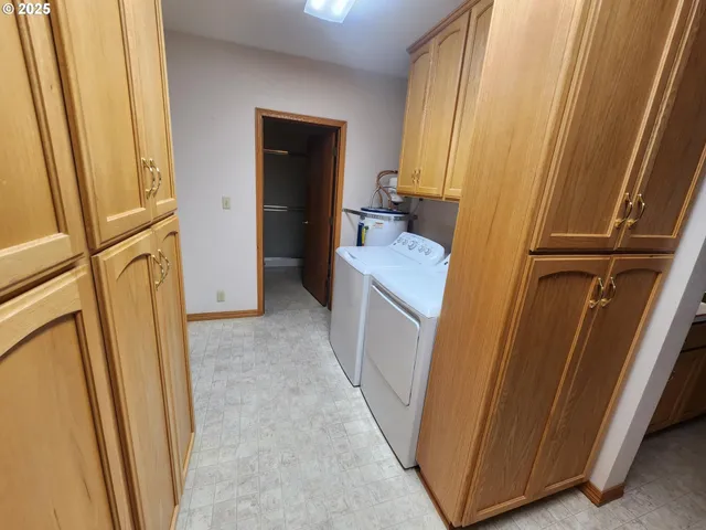 an empty room with a window and a ceiling fan