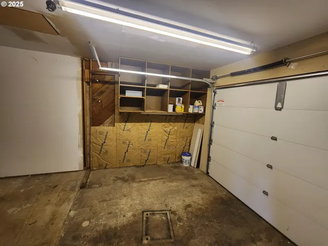 a backyard of a house with chairs and wooden fence