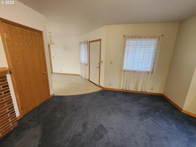 a view of a livingroom with an empty space and a fireplace