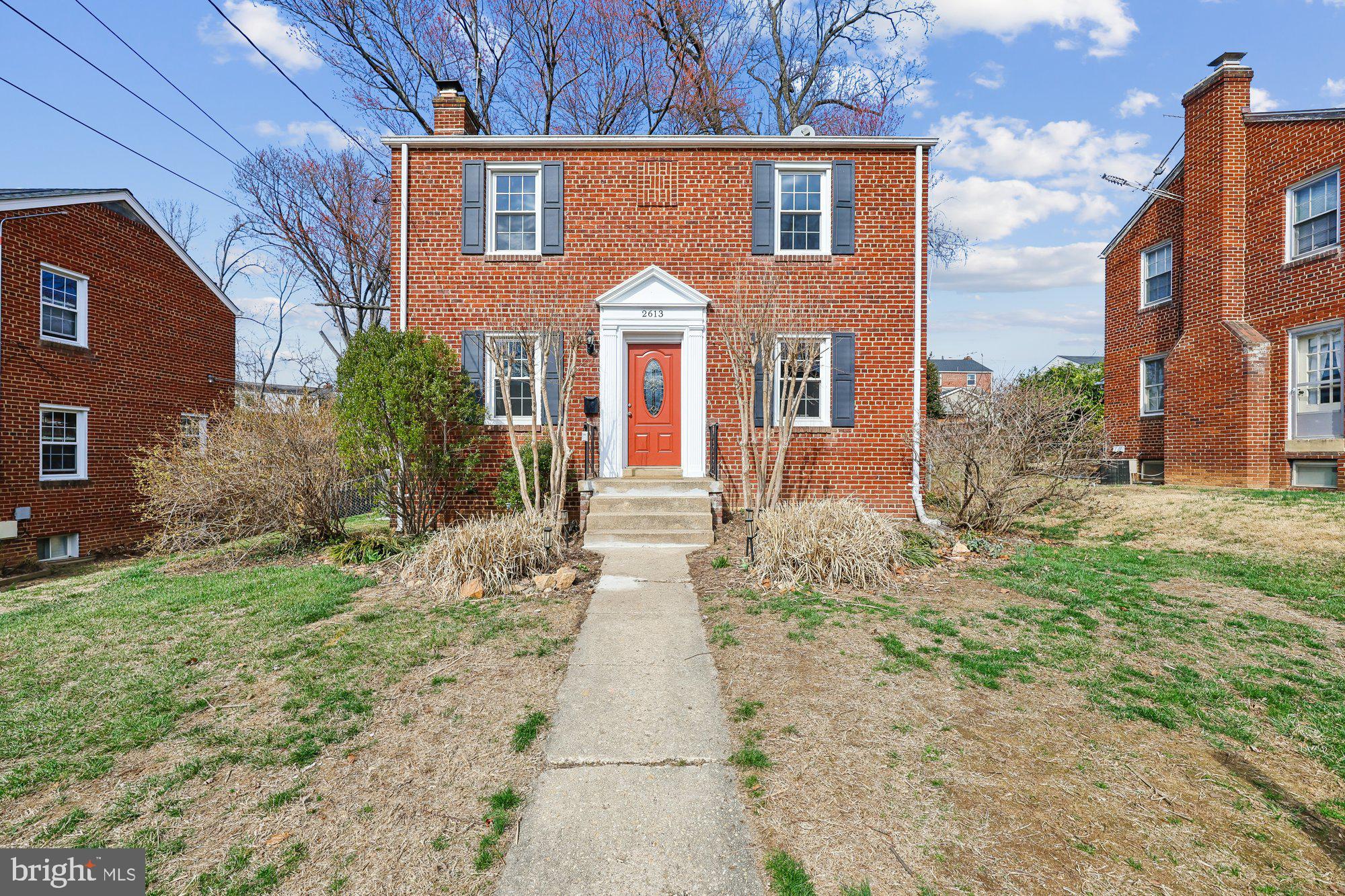 2613 Elnora Street Silver Spring, MD 20902 - Photo 1 of 54 a view of a brick house with many windows next to a yard