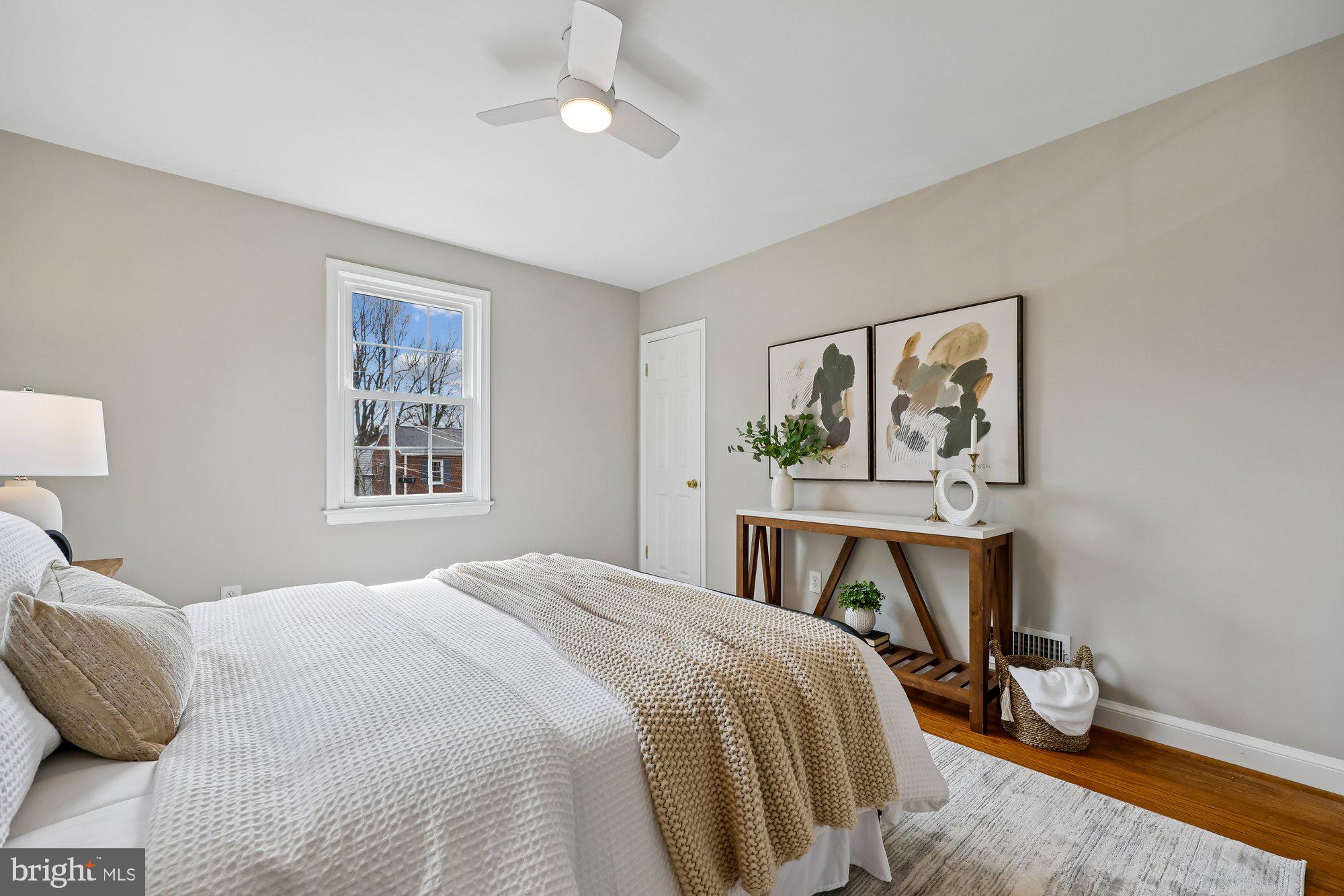 2613 Elnora Street Silver Spring, MD 20902 - Photo 21 of 54 a bedroom with a bed a painting on the wall and a window