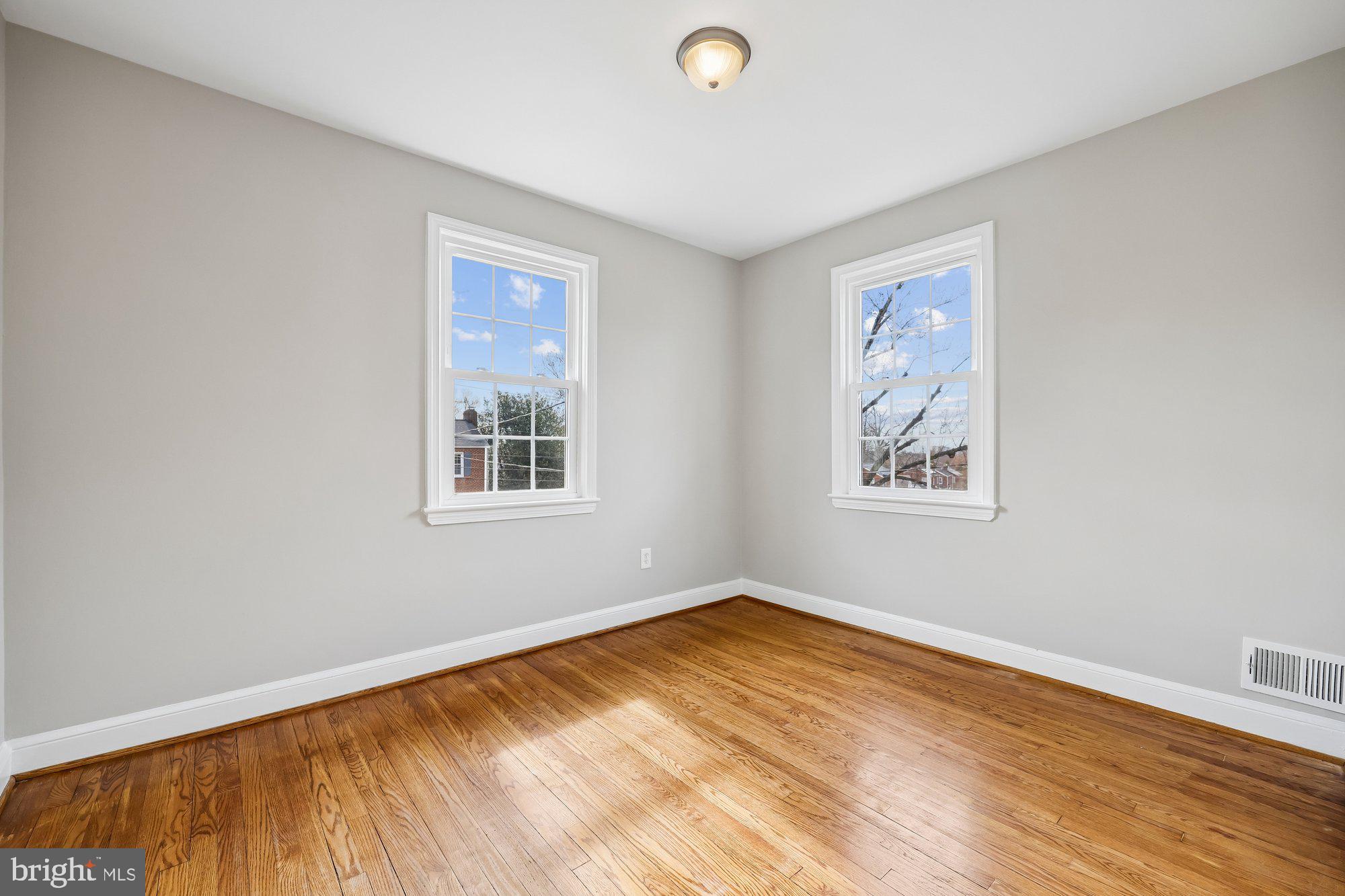 2613 Elnora Street Silver Spring, MD 20902 - Photo 26 of 54 a view of an empty room with wooden floor and a window