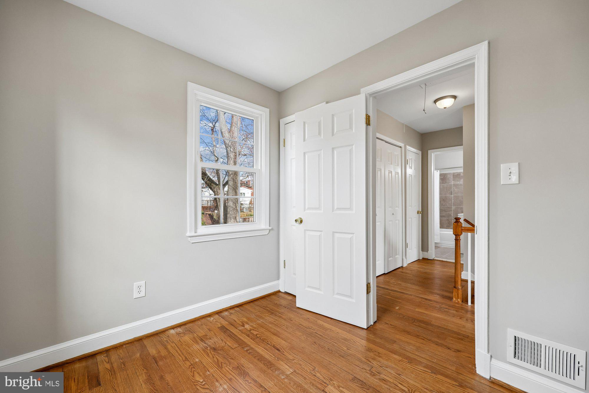 2613 Elnora Street Silver Spring, MD 20902 - Photo 29 of 54 a view of an empty room with wooden floor and a window