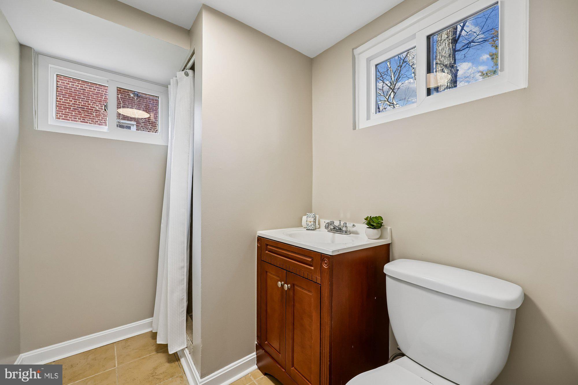 2613 Elnora Street Silver Spring, MD 20902 - Photo 34 of 54 a bathroom with a toilet a sink and mirror