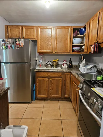 a kitchen with a sink a stove and a refrigerator