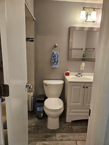 a bathroom with a toilet sink and mirror