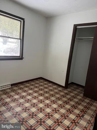 a view of a room with wooden floor and a window