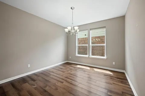 a view of a room with windows and chandelier