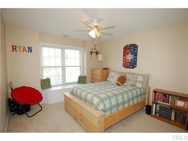 6101 Tiffield Way Wake Forest, NC 27587 - Photo 16 of 25 a bedroom with a bed dresser and a large window