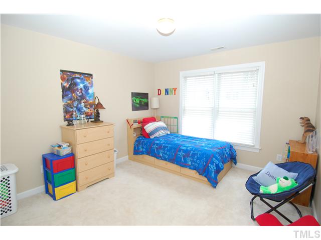 6101 Tiffield Way Wake Forest, NC 27587 - Photo 17 of 25 a bedroom with a bed a couch and a window