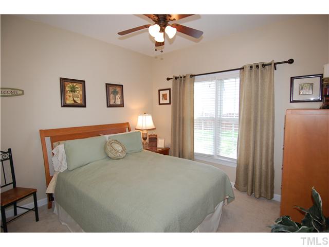 6101 Tiffield Way Wake Forest, NC 27587 - Photo 19 of 25 a bedroom with a bed and a chandelier
