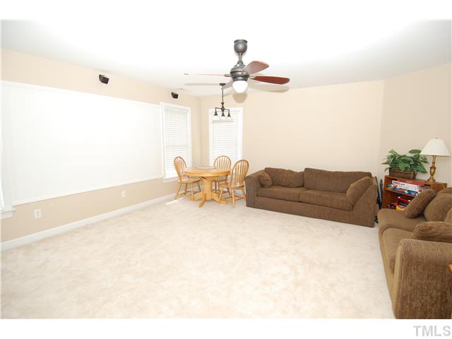 6101 Tiffield Way Wake Forest, NC 27587 - Photo 20 of 25 a living room with furniture and a chandelier