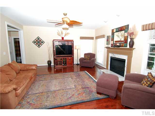 6101 Tiffield Way Wake Forest, NC 27587 - Photo 6 of 25 a living room with furniture and a flat screen tv
