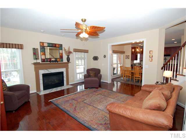 6101 Tiffield Way Wake Forest, NC 27587 - Photo 7 of 25 a living room with furniture a fireplace and a large window