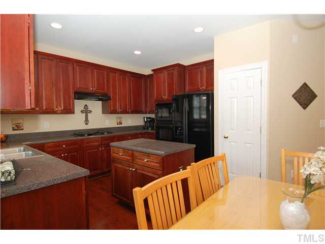 6101 Tiffield Way Wake Forest, NC 27587 - Photo 9 of 25 a kitchen with refrigerator and cabinets