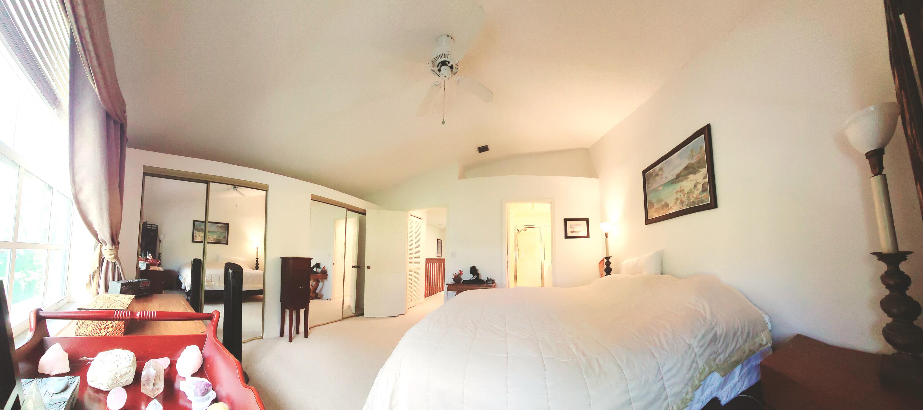 5121 Sabal Gardens Lane, Unit 2 Boca Raton, FL 33487 - Photo 15 of 25 a bed room with a bed and a chandelier
