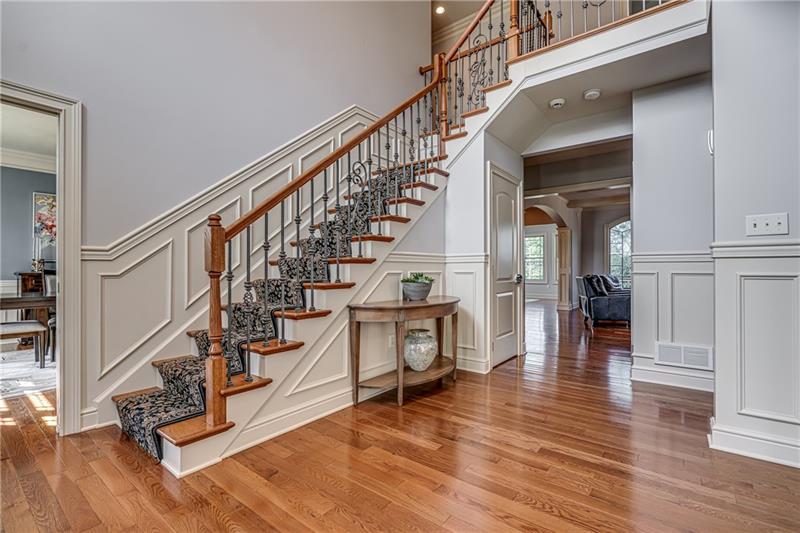 306 Buckingham Drive Venetia, PA 15367 - Photo 2 of 25 Grand two-story entryway with beautiful wainscoting and wood trim. Opens to family room and living room. Dining room is to the left and sitting/living room to the right.