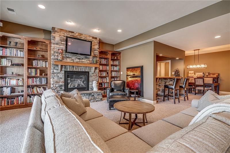 306 Buckingham Drive Venetia, PA 15367 - Photo 20 of 25 Cozy up to the basement gas fireplace with built in bookcases on either side. Great area for Sports watching and family movie night.