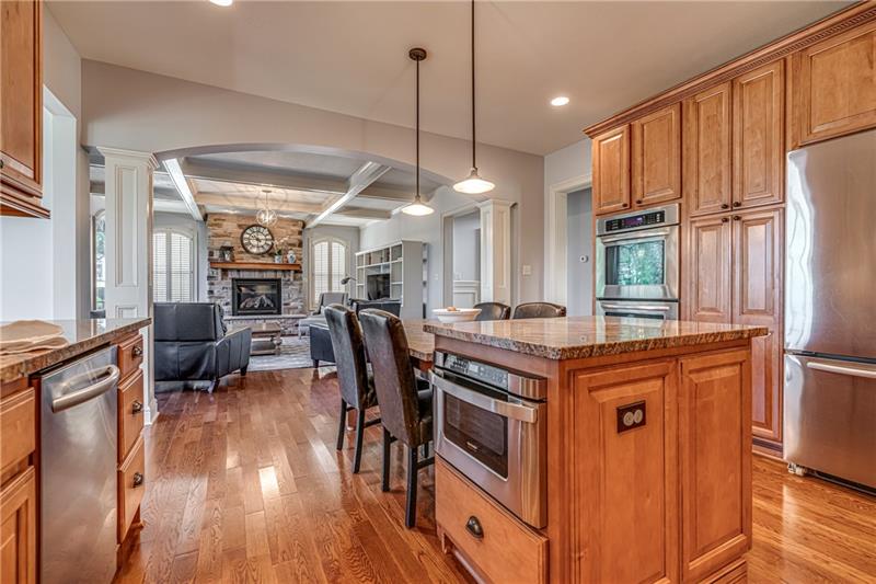 306 Buckingham Drive Venetia, PA 15367 - Photo 5 of 25 Kitchen opens to the large and bright family room. Hardwood flooring throughout the first floor. Upscale stainless steel appliances including double oven.