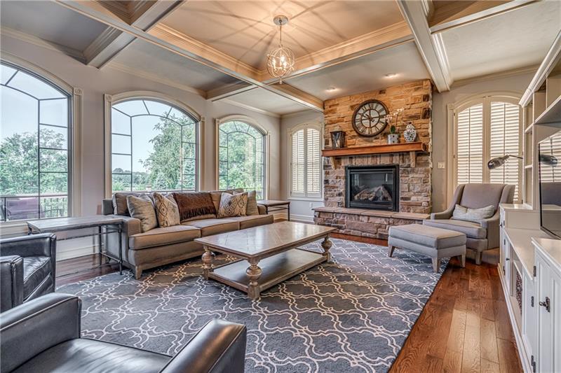 306 Buckingham Drive Venetia, PA 15367 - Photo 6 of 25 Coffered ceiling with large arc windows that overlook outside deck and large fenced in backyard. Warm up in the winter to the gas fireplace.