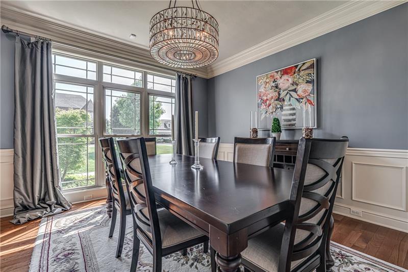 306 Buckingham Drive Venetia, PA 15367 - Photo 7 of 25 Gorgeous dining room with wainscoting and trim throughout. Transom windows in dining and living room to bring in more natural light.