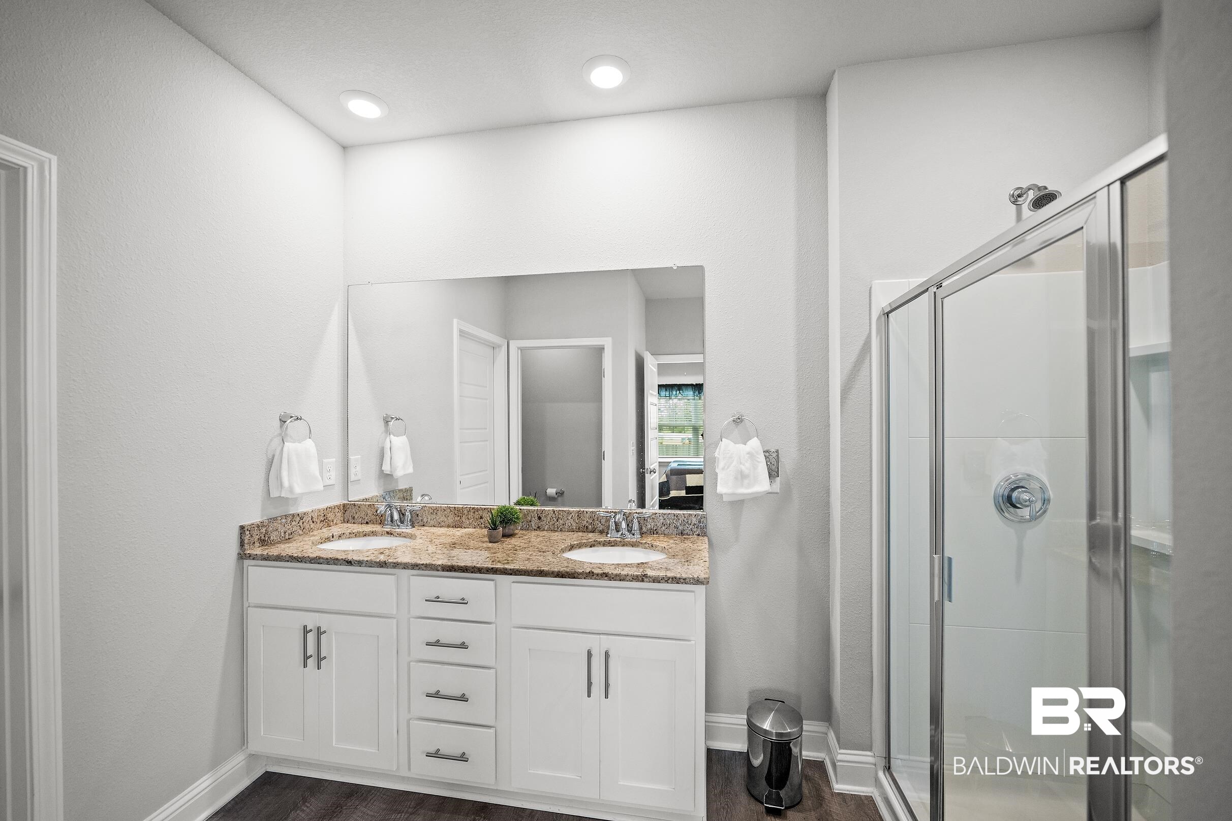 31468 Memphis Loop Daphne, AL 36527 - Photo 12 of 24 Bathroom with double vanity, a stall shower, and dark wood-style floors