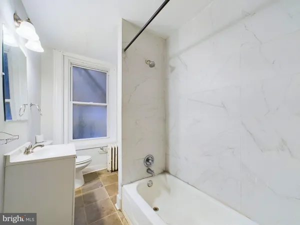 a bathroom with a bathtub and a sink