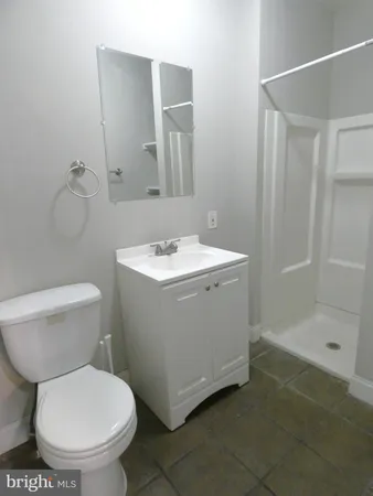 a white toilet sitting next to a bathroom sink