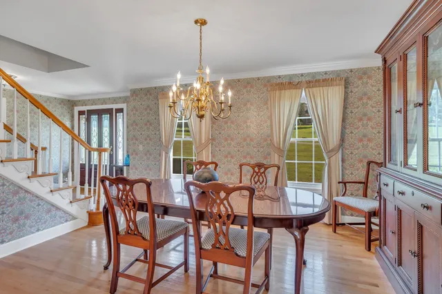 a view of a dining room with furniture and a chandelier