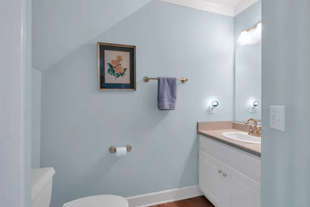 a bathroom with a sink mirror vanity and toilet