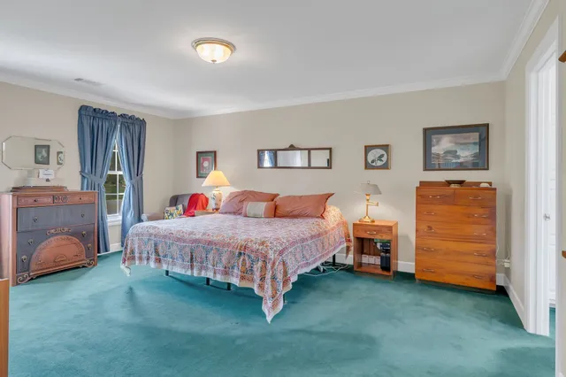 a bedroom with a bed and a desk