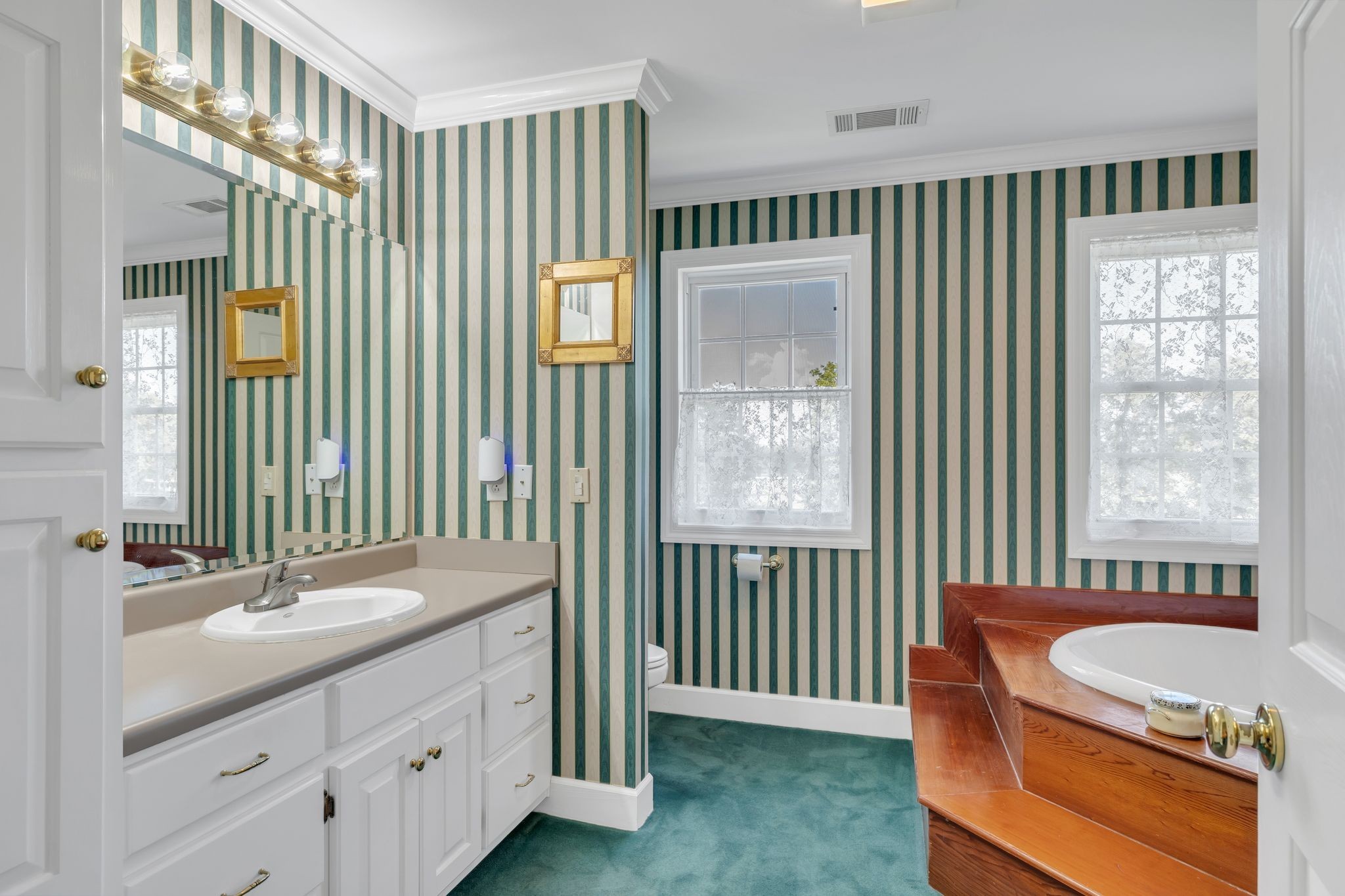 207 Sugar Tree Lane Pulaski, TN 38478 - Photo 26 of 30 a bathroom with a tub a sink and a mirror