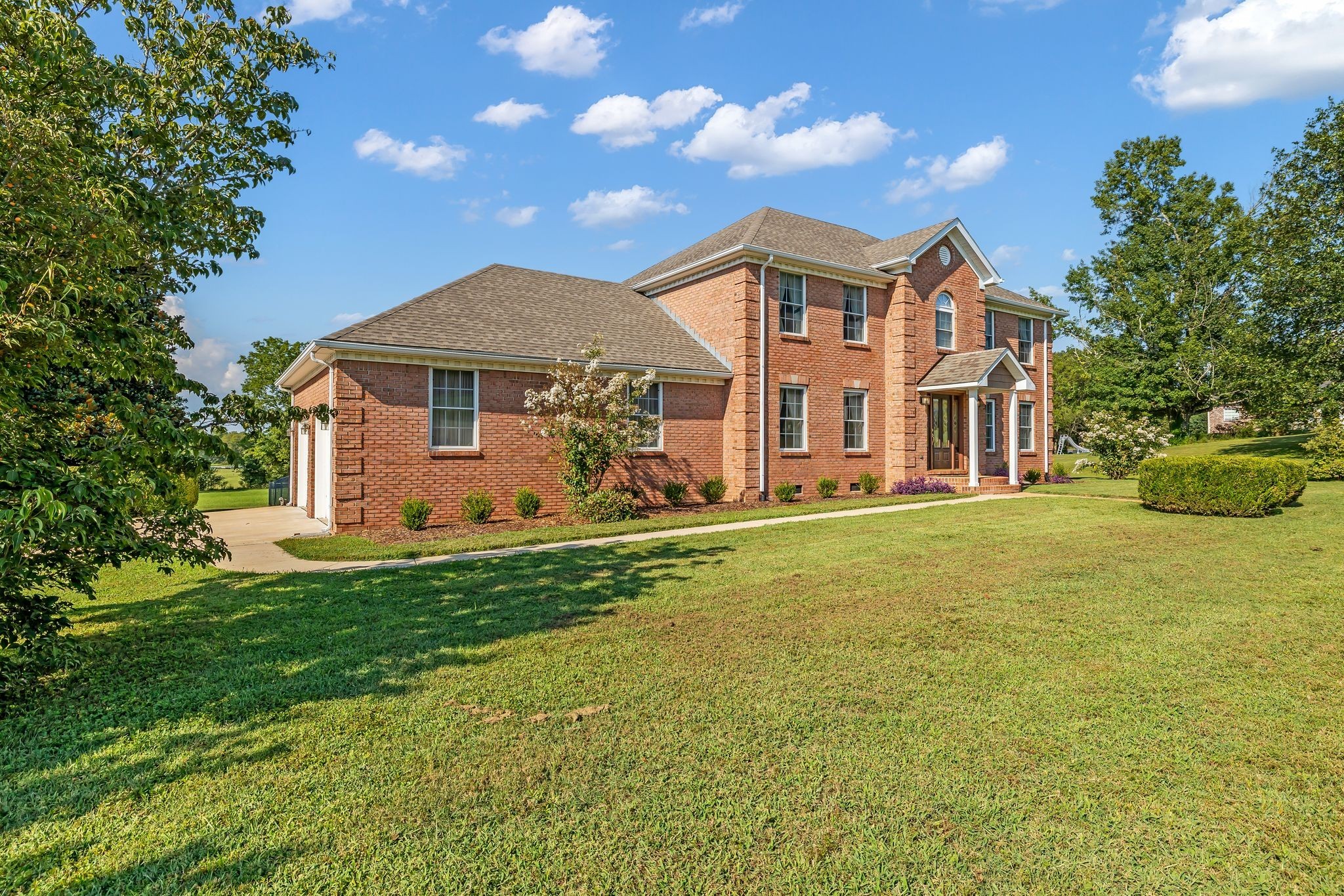 207 Sugar Tree Lane Pulaski, TN 38478 - Photo 3 of 30 a front view of a house with garden